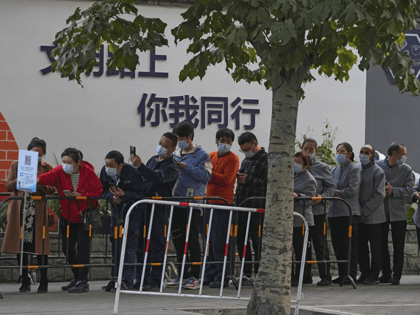 Service sector workers wearing face masks to help curb the spread of the coronavirus line