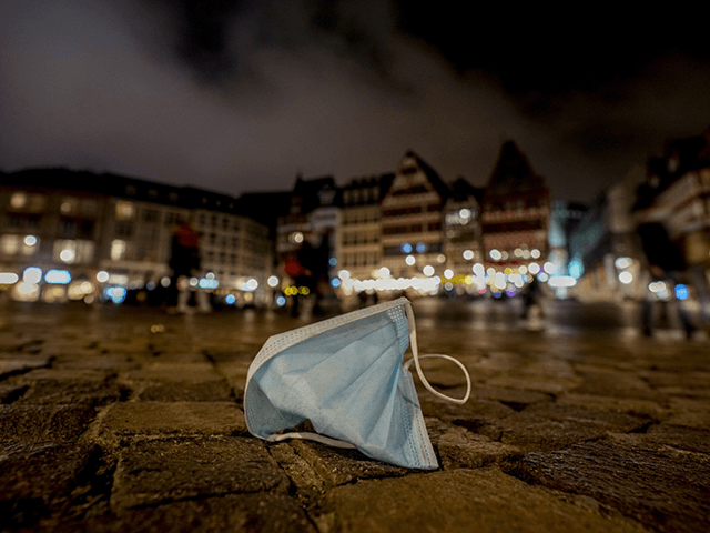 A face mask was left back on the Roemerberg square in Frankfurt, Saturday, Nov.. 6, 2021. (AP Photo/Michael Probst)