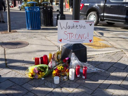WAUKESHA, WI - NOVEMBER 23: Memorials placed along Main Street in downtown Waukesha Wisconsin left in areas where people were hit by a driver plowing into the Christmas parade on Main Street in downtown November 22, 2021 in Waukesha, Wisconsin. Five people were left dead after a person driving an …