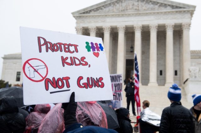 Gun control supporters hold a protest rally outside the US Supreme Court