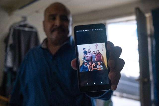 Martin Figueroa shows a picture of the family he left behind when he was deported to Mexic