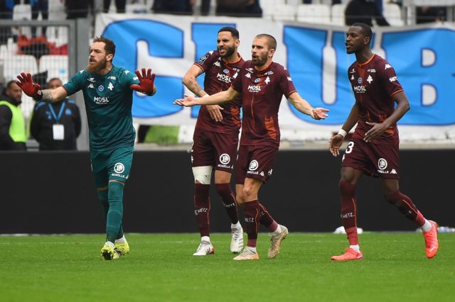 Unhappy: Metz players react after French referee Jerome Brisard gives a red card to Brazil