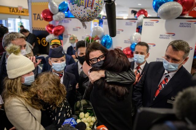 Members of the Erebara family embrace after arriving at JFK international airport in New