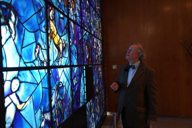 Werner Schmidt, in charge of supervising the UN's art collection admires "Windows" -- a gl