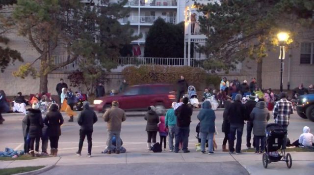 A red SUV is seen speeding through the holiday parade crowd in the city of Waukesha, Wisco