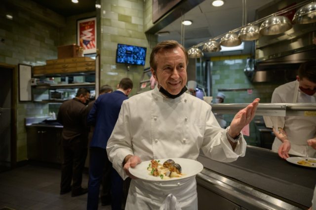 French chef and restaurateur Daniel Boulud works in the kitchen of his restaurant "Daniel,