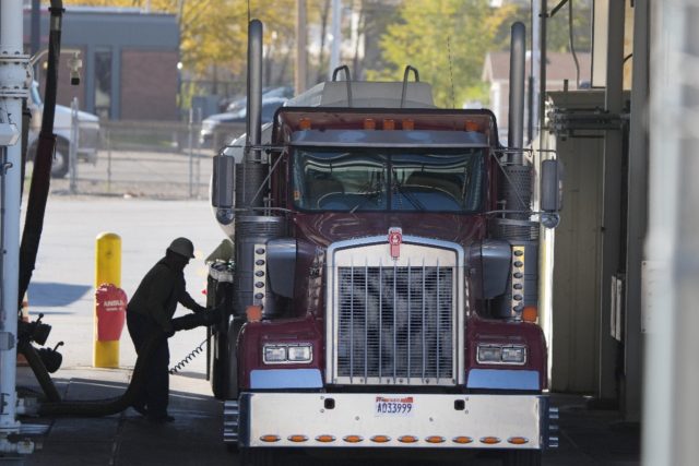A trucker loads his truck with fuel in Salt Lake City, Utah, as residents and businesses in the United States and other nations grapple with high oil and gas prices