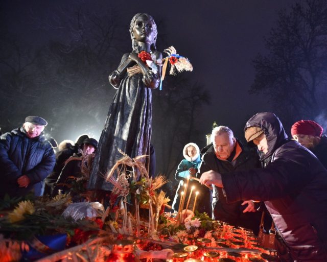 People place candles in memory of the victims of the Holodomor famine in Kiev in 2017