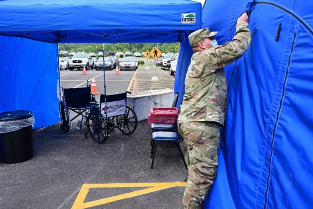 A National Guardsman erects a tent for Covid patients outside a hospital in Kentucky last