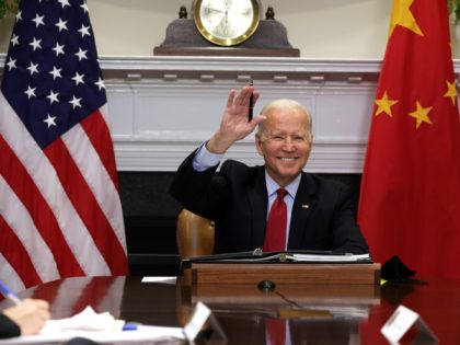 WASHINGTON, DC - NOVEMBER 15: U.S. President Joe Biden waves as he participates in a virtual meeting with Chinese President Xi Jinping at the Roosevelt Room of the White House November 15, 2021 in Washington, DC. President Biden met with his Chinese counterpart to discuss bilateral issues. (Photo by Alex …