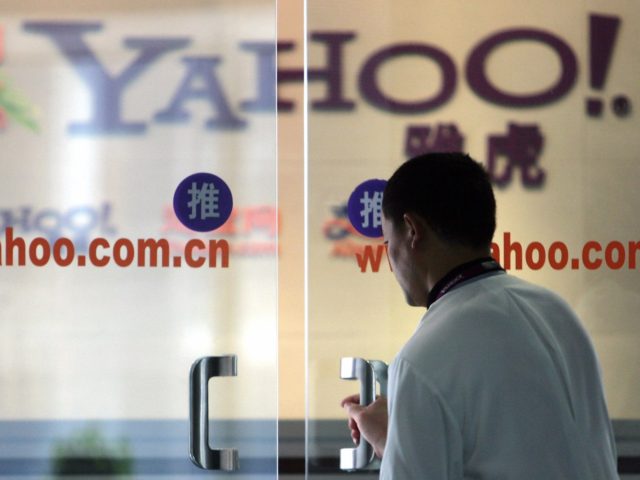 Beijing, CHINA: A Chinese man walks into the offices of Yahoo! China in Beijing, 14 Septem