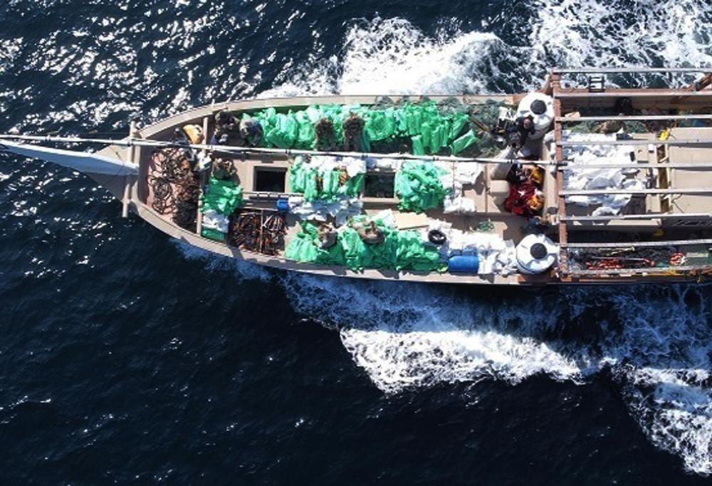 In this Dec. 20, 2021, photo released by the U.S. Navy, service members from patrol coastal ship USS Typhoon, inventory an illicit shipment of weapons while aboard a stateless fishing vessel transiting international waters in the North Arabian Sea. The U.S. Navy seized a large cache of assault rifles and ammunition being smuggled by a fishing ship from Iran likely bound for war-ravaged Yemen, it said late Wednesday. (U.S. Navy via AP)