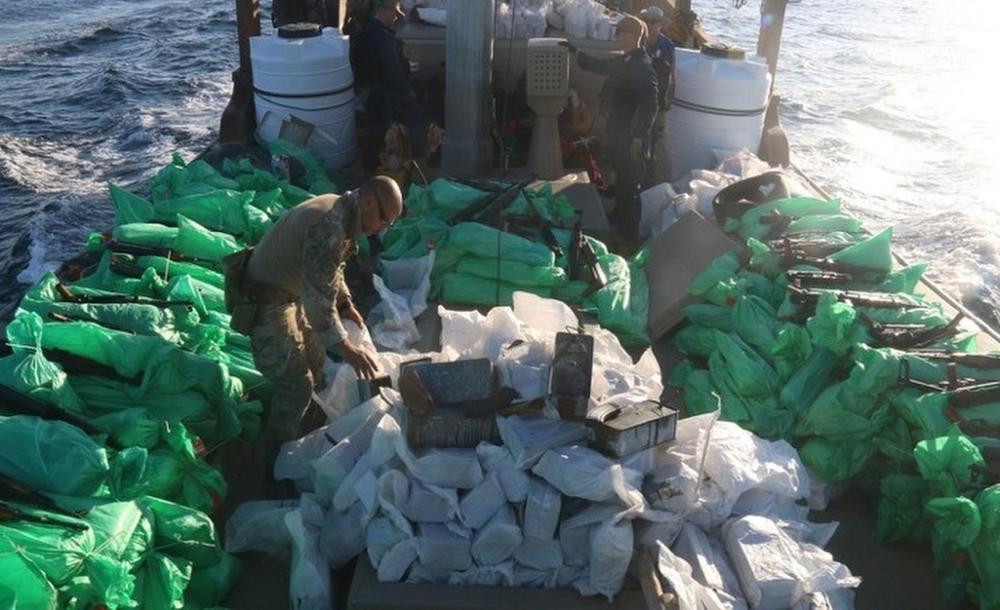 In this Dec. 20, 2021, photo released by the U.S. Navy, service members from patrol coastal ship USS Typhoon, inventory an illicit shipment of weapons while aboard a stateless fishing vessel transiting international waters in the North Arabian Sea. The U.S. Navy seized a large cache of assault rifles and ammunition being smuggled by a fishing ship from Iran likely bound for war-ravaged Yemen, it said late Wednesday. (U.S. Navy via AP)