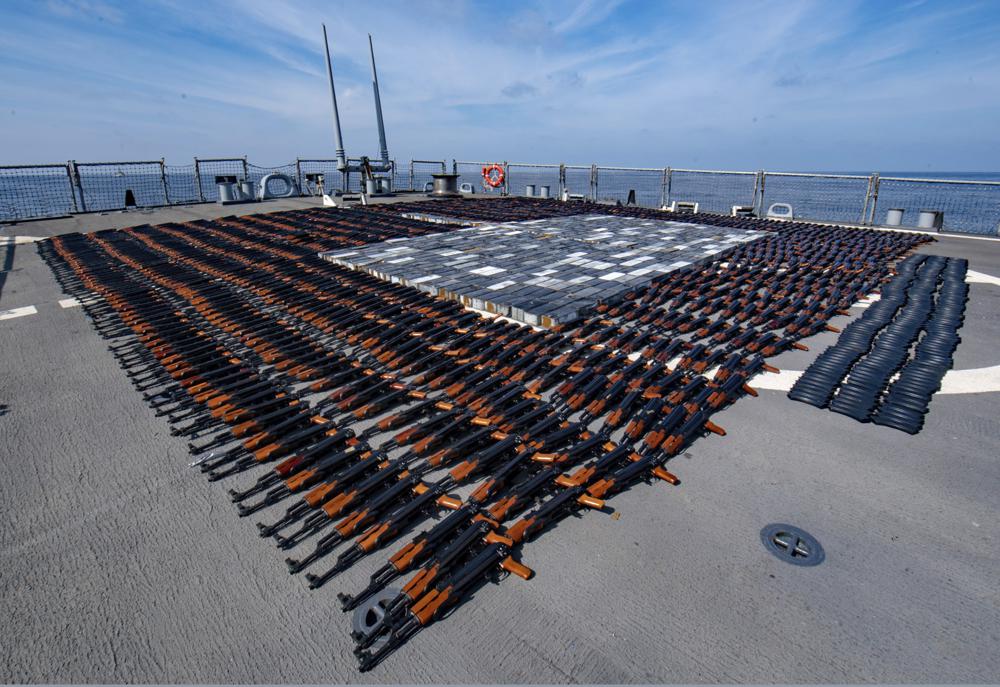In this Dec. 21, 2021, photo released by the U.S. Navy, Illicit weapons seized from a stateless fishing vessel in the North Arabian Sea are arranged for inventory aboard guided-missile destroyer USS O'Kane's (DDG 77) flight deck. The U.S. Navy seized a large cache of assault rifles and ammunition being smuggled by a fishing ship from Iran likely bound for war-ravaged Yemen, it said late Wednesday, Dec. 22. (Mass Communication Specialist Seaman Elisha Smith/U.S. Navy via AP)