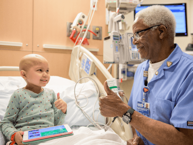 Night Shift Nurse Tommy Covington checks in on patient Teiya Van Meter, 6, at Children’s Hospital Los Angeles. Covington retired from the Children’s Center for Cancer and Blood Diseases at CHLA on Jan. 6, 2017.
