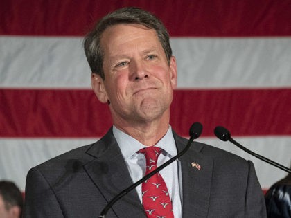 Georgia Secretary of State Brian Kemp appears during a unity rally with daughter Lucy behi