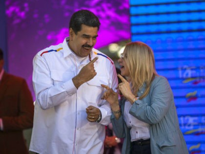 Venezuela's President Nicolas Maduro dances next to his wife, Cilia Flores, during a pro-government demonstration in Caracas, Venezuela, Tuesday, Feb. 12, 2019. Nearly three weeks after the Trump administration backed an all-out effort to force out Venezuelan President Nicolas Maduro, the embattled socialist leader is holding strong and defying predictions …