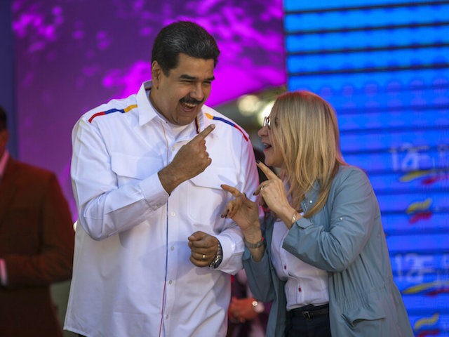 Venezuela's President Nicolas Maduro dances next to his wife, Cilia Flores, during a pro-g