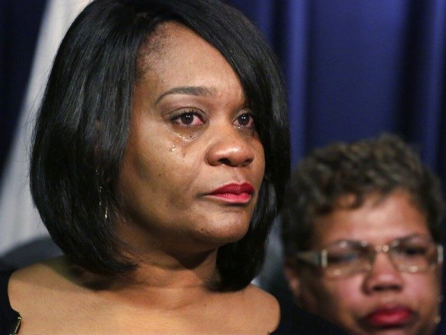 Illinois State Sen. Kimberly A. Lightford, left, becomes emotional during a news conference held by the Illinois Legislative Black Caucus, Monday, Dec. 14, 2015, in Chicago. The group says the Illinois budget stalemate is hurting the black population as youths miss out on financial aid for colleges and after-school programs. …