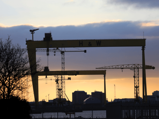 Building cranes stand out in the evening sky in Belfast docks area, Northern Ireland, Tues