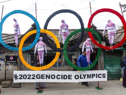 Exile Tibetans use the Olympic Rings as a prop as they hold a street protest against the holding of 2022 Winter Olympics in Beijing in Dharmsala, India, Wednesday, Feb. 3, 2021. Five effigies represent Taiwan, Tibet, Hong Kong, Inner Mongolia and the region ethnic Uighurs call 'East Turkestan', under Chinese …