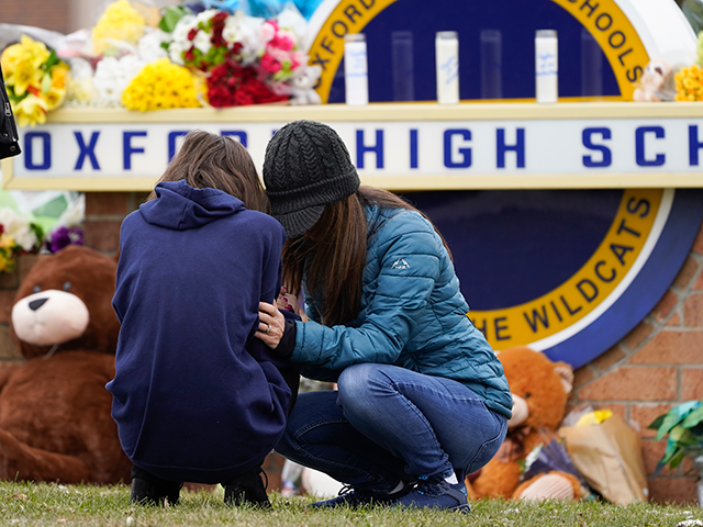 Mourners grieve at Oxford High School in Oxford, Mich., Wednesday, Dec. 1, 2021. Authoriti