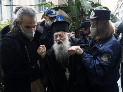 Police hold a protesting Orthodox Priest during the visit of Pope Francis at the Archbisho