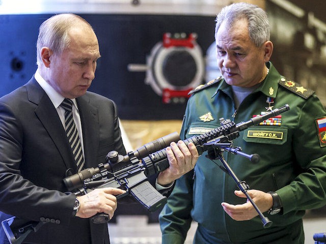 Russian President Vladimir Putin, left, and Russian Defense Minister Sergei Shoigu visit a