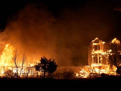 Homes burn as a wildfire rips through a development near Rock Creek Village, Thursday, Dec. 30, 2021, near Broomfield, Colo.
