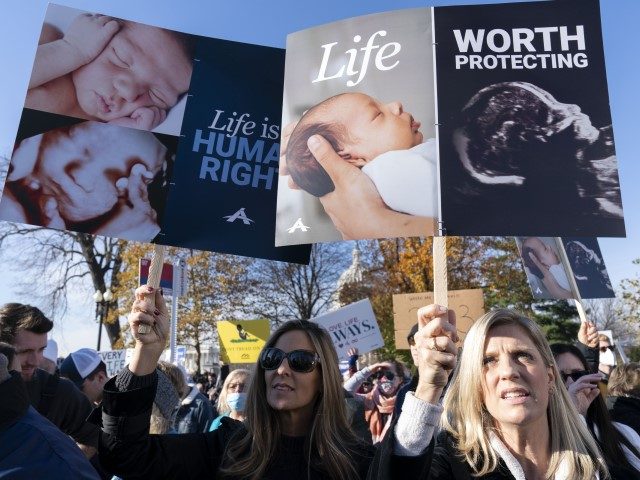Anti-abortion protesters demonstrate in front of the U.S. Supreme Court Wednesday, Dec. 1, 2021, in Washington, as the court hears arguments in a case from Mississippi, where a 2018 law would ban abortions after 15 weeks of pregnancy, well before viability.