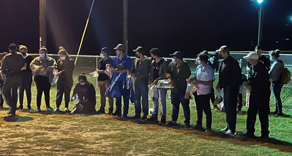 Border Patrol agents process migrants on Christmas Eve on an athletic field near the Texas border with Mexico. (Randy Clark/Breitbart Texas)