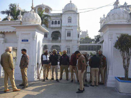 Indian policemen stand guard outside the office of Shiromani Gurdwara Parbandhak Committee