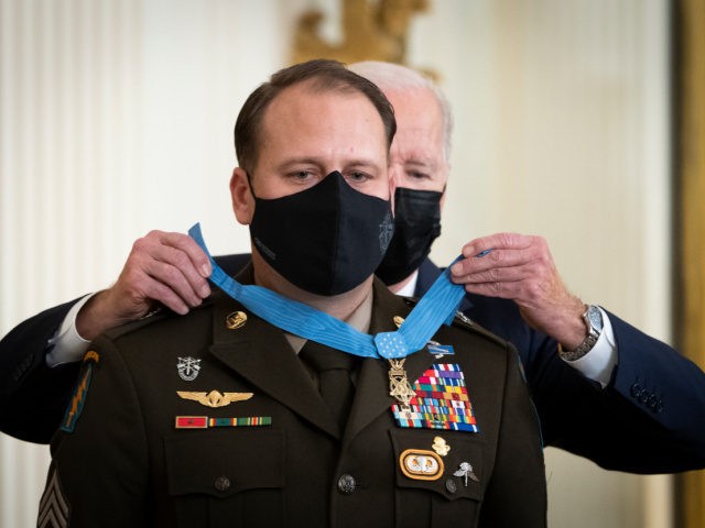 WASHINGTON, DC - DECEMBER 16: U.S. President Joe Biden awards the Medal of Honor to Army Master Sgt. Earl Plumlee in the East Room of the White House December 16, 2021 in Washington, DC. Plumlee, an Army Green Beret, is receiving the medal for his efforts to repel a suicide …
