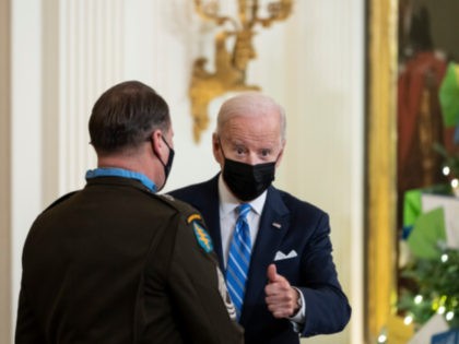 WASHINGTON, DC - DECEMBER 16: U.S. President Joe Biden gives the thumbs up after awarding the Medal of Honor to Army Master Sgt. Earl Plumlee in the East Room of the White House December 16, 2021 in Washington, DC. Plumlee, an Army Green Beret, is receiving the medal for his …