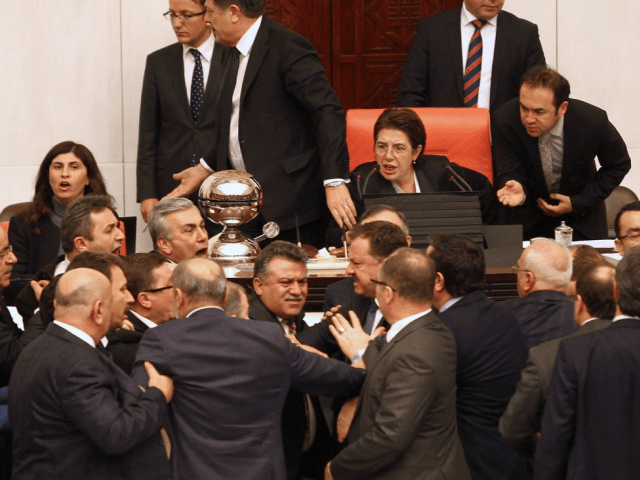 Turkish lawmakers from the opposition and ruling AK Party scuffle during a debate on a new security bill critics claim could turn the country back into a "police state" at the Turkish Parliament in Ankara, on February 24, 2015. AFP PHOTO/ADEM ALTAN (Photo credit should read ADEM ALTAN/AFP via Getty …