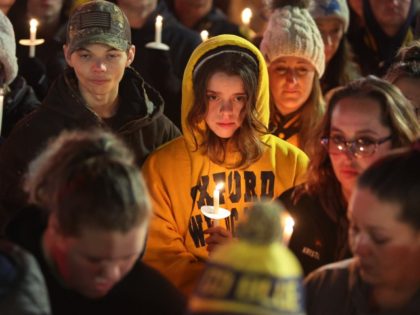 OXFORD, MICHIGAN - DECEMBER 03: People attend a vigil downtown to honor those killed and wounded during the recent shooting at Oxford High School on December 3, 2021 in Oxford, Michigan. Four students were killed and seven others injured on November 30, when student Ethan Crumbley allegedly opened fire with …