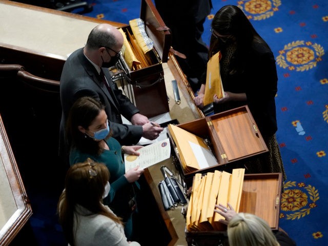 WASHINGTON, DC - JANUARY 06: Congressional aides examine electoral college votes in the Ho