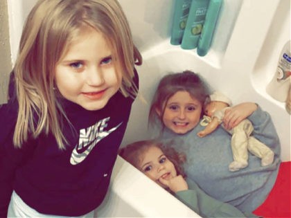 In this Dec. 10, 2021, photo provided by Sandra Hooker, from left, Avalinn Rackley, 7, Alanna Rackley, 3, and Annistyn Rackley, 9, pose for a picture in a bathroom in their home near Caruthersville, Missouri. Annistyn, a third-grader who loved swimming, dancing and cheerleading, was among dozens of people who …