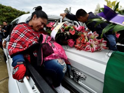 Relatives of indigenous leader Cristina Bautista, who was killed along with four indigenous guards during an attack by suspected rebels, mourn as they transport the coffin with her corpse during their funeral in Tacueyo, rural area of Toribio, department of Cauca, Colombia, on October 31, 2019. - Colombia's government on …