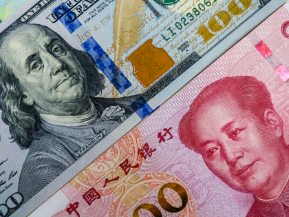 Face to face of US dollar banknote and China Yuan banknote