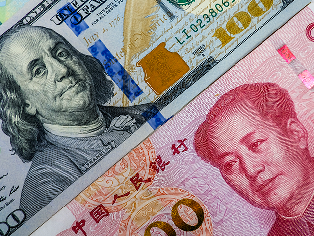 Face to face of US dollar banknote and China Yuan banknote
