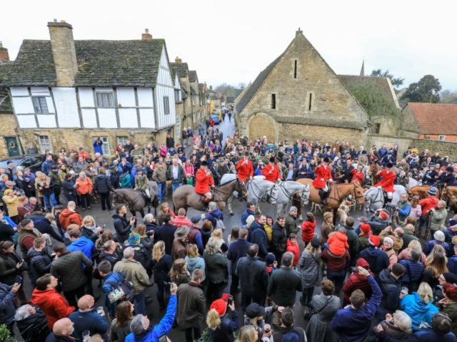 LACOCK, WILTSHIRE - DECEMBER 26: Hunt supporters greet riders as the huntsman toast towar