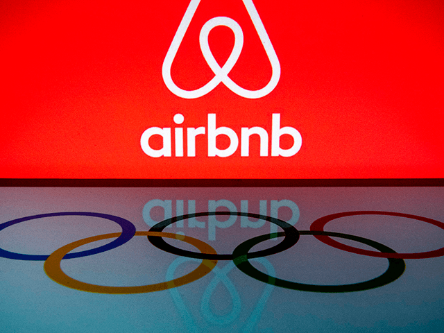This illustration picture taken on November 22, 2019, shows the logo of the online lodging service Airbnb and the Olympic rings displayed on a smartphone and a tablet in Paris. (Photo by Lionel BONAVENTURE / AFP) (Photo by LIONEL BONAVENTURE/AFP via Getty Images)
