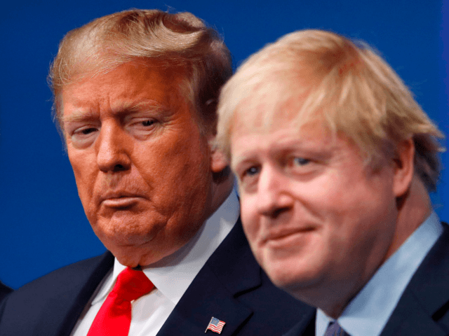 TOPSHOT - Britain's Prime Minister Boris Johnson (R) welcomes US President Donald Trump (L) to the NATO summit at the Grove hotel in Watford, northeast of London on December 4, 2019. (Photo by PETER NICHOLLS / various sources / AFP) (Photo by PETER NICHOLLS/AFP via Getty Images)
