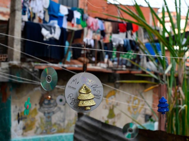 Old CDs turned into Christmas ornaments hang in an alley at the Artigas neighbourhood in C