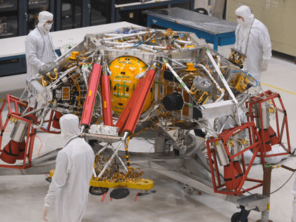 NASA engineers and technicians examine the descent stage of the Mars 2020 spacecraft, December 27, 2019 during a media tour of the Mars2020 Spacecraft Assembly Facility clean room at NASA's Jet Propulsion Laboratory in Pasadena, California. - The Mars 2020 rover, which will take off in a few months to …