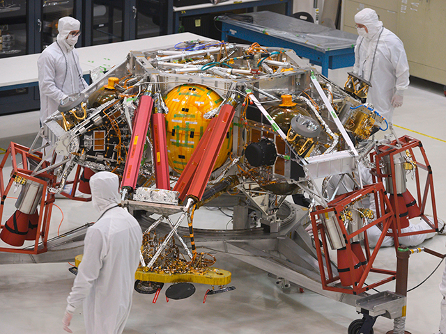 NASA engineers and technicians examine the descent stage of the Mars 2020 spacecraft, Dece