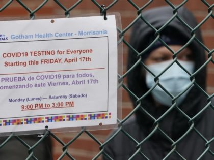 People wait in line for a coronavirus test at one of the new walk-in COVID-19 testing sites that opened in the parking lot of NYC Health + Hospitals/Gotham Health Morrisania in the Bronx Section of New York on April 20. 2020.