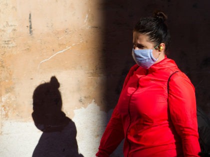 A woman wearing a face mask walks in Palma de Mallorca on May 11, 2020 as Spain moved towa