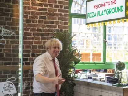 LONDON, ENGLAND - JUNE 26: British Prime Minister Boris Johnson speaks with operations Manager, Bledi, during a visit to Pizza Pilgrims in West India Quay, London Docklands, as they prepare to reopen as lockdown rules are eased on July 4th, on June 26, 2020 in London, England. (Photo by Heathcliff …
